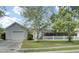 Charming single-story home boasts a lush lawn, white picket fence, and an attached one-car garage at 318 Seneca River Dr, Summerville, SC 29485