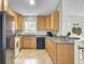 Charming kitchen with wood cabinets, black appliances and a sunny window overlooking the backyard at 318 Seneca River Dr, Summerville, SC 29485