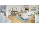 Open living room with stylish furnishings, including a gray sofa, white chairs, and a decorative rug with beachy tones at 318 Seneca River Dr, Summerville, SC 29485