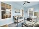 Inviting sunroom featuring a neutral sofa, coastal artwork, and natural light at 318 Seneca River Dr, Summerville, SC 29485