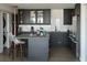 Modern kitchen with sleek black cabinetry, stainless steel appliances, and white subway tile backsplash at 330 Concord St # 14D, Charleston, SC 29401