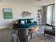 Modern living room with hardwood floors, a couch, artwork and large windows at 330 Concord St # 14D, Charleston, SC 29401