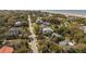 An aerial view of the street and the homes nestled among tall trees and palm trees at 3308 Myrtle St, Edisto Beach, SC 29438