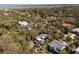 An aerial view shows the neighborhood homes surrounded by lush trees and greenery at 3308 Myrtle St, Edisto Beach, SC 29438