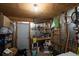 Unfinished storage area with a light fixture, shelves, and various storage containers at 3308 Myrtle St, Edisto Beach, SC 29438