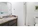 Cozy bathroom featuring a granite vanity, toilet, and shower with bright natural light at 3308 Myrtle St, Edisto Beach, SC 29438