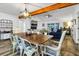 Open-concept dining area with a wooden table, stylish chairs, and views into the living room at 3308 Myrtle St, Edisto Beach, SC 29438