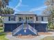 The house features a blue and white exterior, with a well-manicured yard and beautiful landscaping at 3308 Myrtle St, Edisto Beach, SC 29438