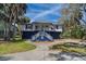 Charming coastal home with elevated design, staircase entry, and quaint front porch at 3308 Myrtle St, Edisto Beach, SC 29438