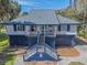 Charming coastal home with elevated design, staircase entry, and quaint front porch at 3308 Myrtle St, Edisto Beach, SC 29438