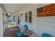 Inviting front porch with cozy seating and American flag decor for a patriotic welcome at 3308 Myrtle St, Edisto Beach, SC 29438