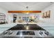 Open-concept kitchen featuring stainless steel appliances and a breakfast bar at 3308 Myrtle St, Edisto Beach, SC 29438