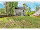Expansive backyard featuring lush lawn, mature trees and a patio with furniture set at 3374 Dunwick Dr, Johns Island, SC 29455