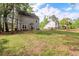 Large backyard featuring well-maintained grass, a patio with furniture, and mature trees at 3374 Dunwick Dr, Johns Island, SC 29455