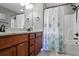 Bathroom with double vanity, tile floors and shower with curtain at 3374 Dunwick Dr, Johns Island, SC 29455