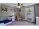 Bedroom including a rocking chair and crib with tasteful decorations and ample natural light at 3374 Dunwick Dr, Johns Island, SC 29455