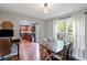 Open dining room that flows into the kitchen, with wood floors and natural light from the windows at 3374 Dunwick Dr, Johns Island, SC 29455