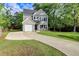 Charming two-story home with a well-manicured lawn and a long driveway leading to the attached garage at 3374 Dunwick Dr, Johns Island, SC 29455