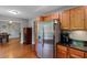 Kitchen area with stainless steel fridge, wooden cabinets and granite countertops at 3374 Dunwick Dr, Johns Island, SC 29455
