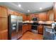 Well-lit kitchen featuring stainless steel appliances, wooden cabinets and hardwood floors at 3374 Dunwick Dr, Johns Island, SC 29455