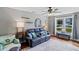 Comfortable living room with a ceiling fan, sofa with pillows, and window with lots of natural light at 3374 Dunwick Dr, Johns Island, SC 29455