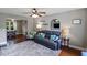 Cozy living room featuring a comfortable leather sofa, ceiling fan, and view into the dining area at 3374 Dunwick Dr, Johns Island, SC 29455