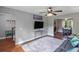Bright living room featuring wood floors, ceiling fan, view to the dining room, and entertainment center at 3374 Dunwick Dr, Johns Island, SC 29455