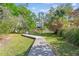 Scenic backyard with a wooden boardwalk leading to private dock access, blending nature and tranquility at 339 Clayton Dr, Charleston, SC 29414