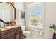 Bathroom with granite countertop, wood vanity, and natural light at 339 Clayton Dr, Charleston, SC 29414