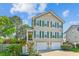 Beautiful home featuring green shutters, a two-car garage, and a quaint porch on a sunny day at 339 Clayton Dr, Charleston, SC 29414