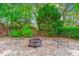 Cozy backyard fire pit with Adirondack chairs, surrounded by lush greenery, perfect for outdoor gatherings at 339 Clayton Dr, Charleston, SC 29414