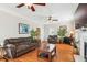Cozy living room with hardwood floors, a fireplace, and comfortable brown sofas at 339 Clayton Dr, Charleston, SC 29414