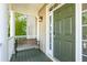 Cozy front porch with a bench, column supports, and a charming olive-green front door at 339 Clayton Dr, Charleston, SC 29414