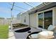 Covered patio features a decorative rug, comfortable seating, and sliding glass doors to bring the outside in at 341 Matuskovic Dr, Charleston, SC 29414