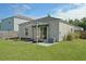 Well-maintained backyard with covered patio, modern seating area, garden beds, and an expansive lawn at 341 Matuskovic Dr, Charleston, SC 29414