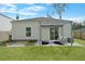 The backyard has a covered patio with stylish seating area, garden beds, and a well-maintained lawn at 341 Matuskovic Dr, Charleston, SC 29414