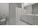 Bright bathroom with a double sink vanity, white cabinets and a shower with a white curtain at 341 Matuskovic Dr, Charleston, SC 29414