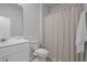 Well-lit half bathroom with a single vanity, white sink, and a shower with neutral curtain at 341 Matuskovic Dr, Charleston, SC 29414