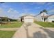 Charming single-story home features a one car garage, welcoming porch, beautiful lawn, and long driveway at 341 Matuskovic Dr, Charleston, SC 29414