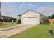 Detached two-car garage with neutral siding complemented by a well-kept lawn and a lengthy driveway at 341 Matuskovic Dr, Charleston, SC 29414