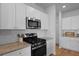 Updated kitchen with white cabinetry, modern appliances, tile backsplash and hardwood floors at 341 Matuskovic Dr, Charleston, SC 29414