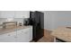 Kitchen featuring a black refrigerator, white cabinets and granite countertops at 341 Matuskovic Dr, Charleston, SC 29414