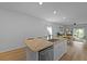 Bright kitchen featuring an island with a sink and dishwasher, hardwood floors, and an open floorplan at 341 Matuskovic Dr, Charleston, SC 29414