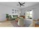 Cozy living room features a comfortable green sofa and a sliding glass door to the backyard at 341 Matuskovic Dr, Charleston, SC 29414
