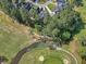 Gorgeous aerial view of golf course, sand traps, pond, and homes nestled amongst trees at 347 Prestwick Ct, Summerville, SC 29483