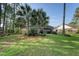 Serene backyard featuring green grass, mature trees, and an inviting patio area at 347 Prestwick Ct, Summerville, SC 29483