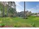 Expansive backyard with lush lawn, mature trees, and patio area for outdoor enjoyment at 347 Prestwick Ct, Summerville, SC 29483