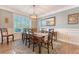 Bright dining room features modern lighting and windows overlooking the backyard at 347 Prestwick Ct, Summerville, SC 29483