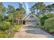 Inviting home with manicured landscaping, two-car garage, and a welcoming front entrance at 347 Prestwick Ct, Summerville, SC 29483