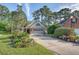 Charming one-story home with brick facade, lush landscaping, and an expansive driveway at 347 Prestwick Ct, Summerville, SC 29483